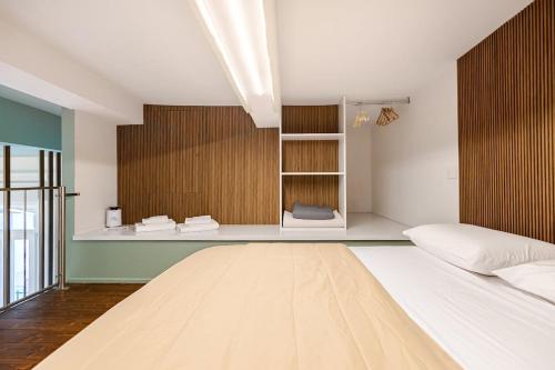 a bedroom with a bed and a book shelf at Living Calabriando in Reggio di Calabria