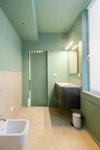 a bathroom with a sink and a toilet and a mirror at Living Calabriando in Reggio di Calabria