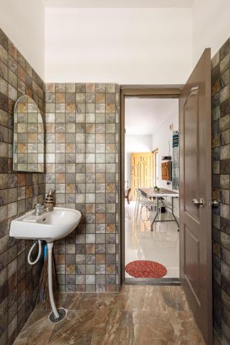 a bathroom with a sink and a table at Paradise Pool by StayJadePoolGarden30min E-city in Hosūr