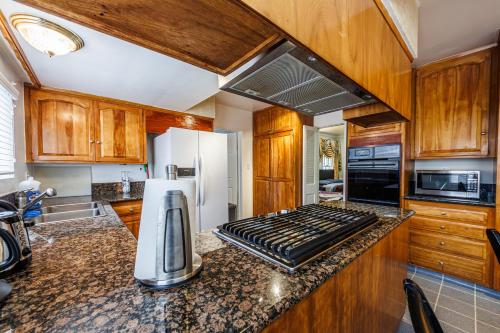 a kitchen with wooden cabinets and a counter top at Beautiful Location By The Beach in Los Angeles