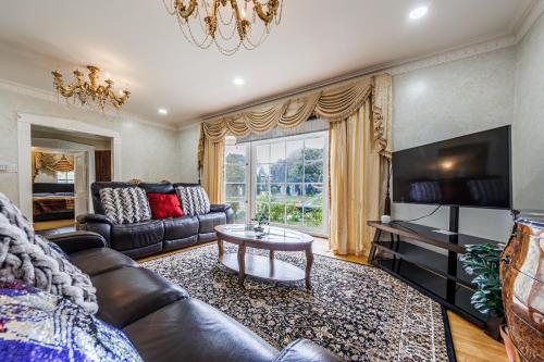 a living room with a couch and a tv at Beautiful Location By The Beach in Los Angeles