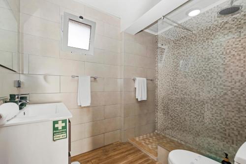 a bathroom with a toilet and a sink and a shower at Casa da Feira - Located in a peaceful Calheta area with sea views in Calheta