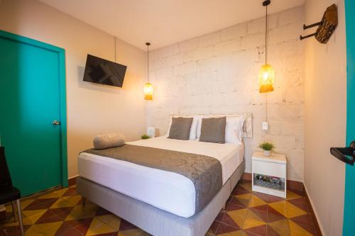 En eller flere senge i et værelse på CASA HOTEL LAS HORTENSIAS