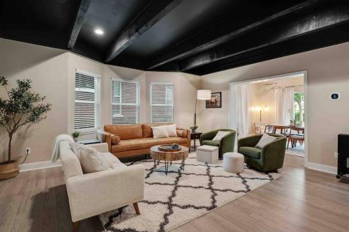a living room with couches and chairs and a table at Memphis Midtown Oasis in Memphis