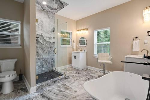 a bathroom with a shower and a toilet and a sink at Memphis Midtown Oasis in Memphis