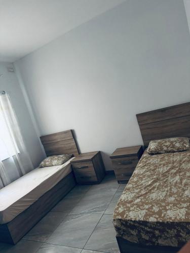 a bedroom with two beds and a window at Private Double bedroom In Marsaskala2 in Il-Ħamrija