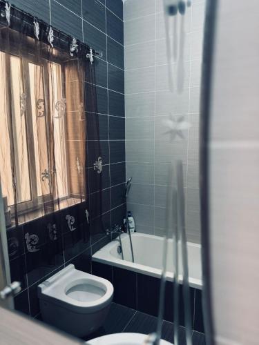 a bathroom with a toilet and a tub and a sink at Private Double bedroom In Marsaskala2 in Il-Ħamrija
