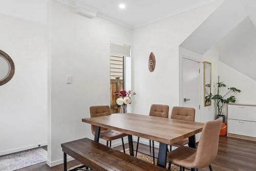 a dining room with a wooden table and chairs at Standalone Home Near Bruce Pulman Park 5BR 3 Baths in Auckland
