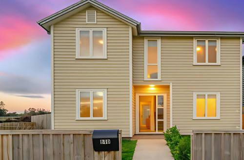a house with a fence in front of it at Standalone Home Near Bruce Pulman Park 5BR 3 Baths in Auckland