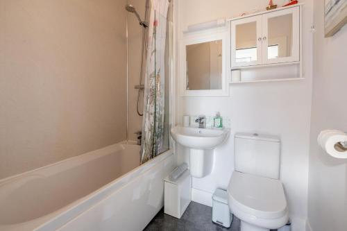 a white bathroom with a toilet and a sink at 1 Bed in Errol oc-s33022 in Errol