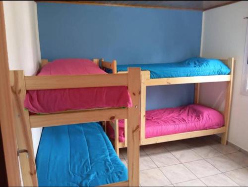 two bunk beds in a room with blue walls at El Atardecer in Villa Giardino