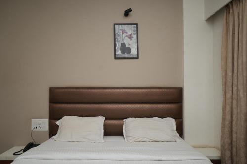 Een bed of bedden in een kamer bij Fortune Resort by Cayana Stays