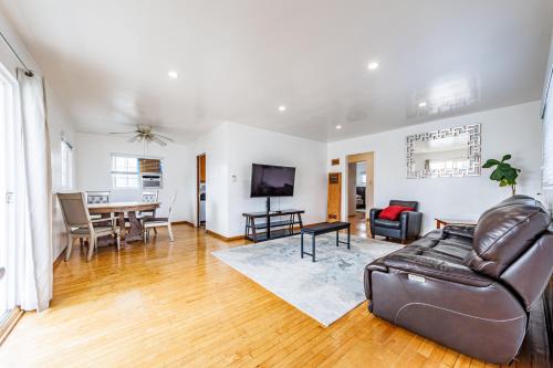 a living room with a leather couch and a table at Spacious Two Bedroom in Santa Monica #E in Los Angeles