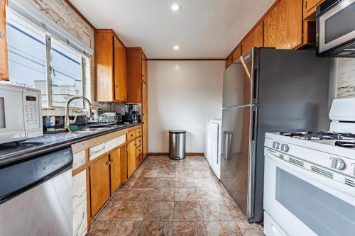 a kitchen with wooden cabinets and stainless steel appliances at Spacious Two Bedroom in Santa Monica #E in Los Angeles
