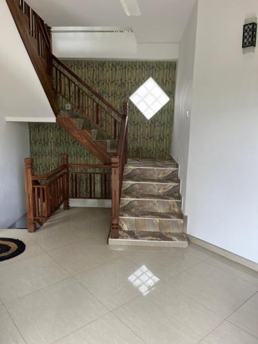 a wooden staircase in a room with a window at Galle City Guest in Galle