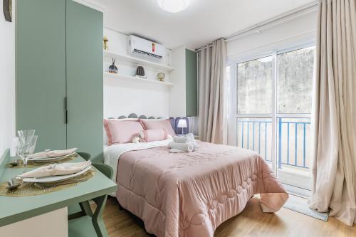 a bedroom with a pink bed and a window at Apê novo, moderno, a 50 metros metrô República in São Paulo
