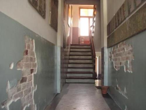 a hallway with stairs and a window in a building at Apartment Kunst Asyl by Interhome in Quedlinburg