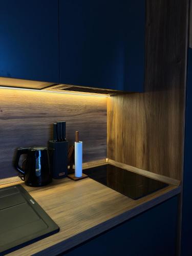 a counter with a coffee pot and a candle on it at Mountain Hearth - Milmari Resort in Kopaonik