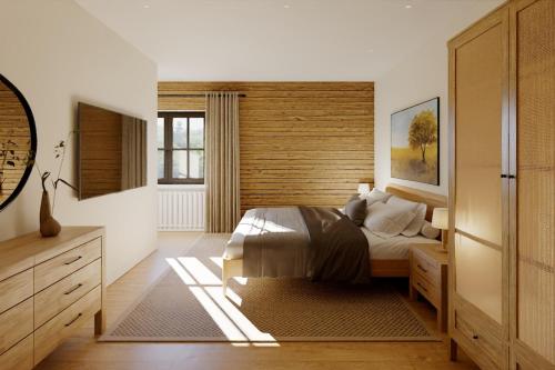 une chambre avec un lit et un mur en bois dans l'établissement Ferienwohnung Jehl am Tegernsee, à Bad Wiessee