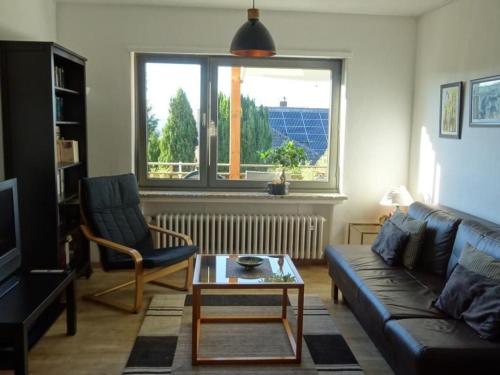 a living room with a couch and a table and a window at Apartment Jakobs by Interhome in Vlotho