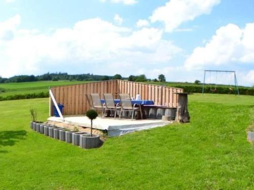 a house with a picnic table in a field at Apartment Haus-Trapp by Interhome in Unterbernhards