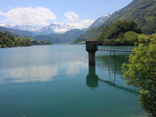 a view of a lake with a bridge and mountains at Apartment Bemer-Rempfler by Interhome in Bürglen