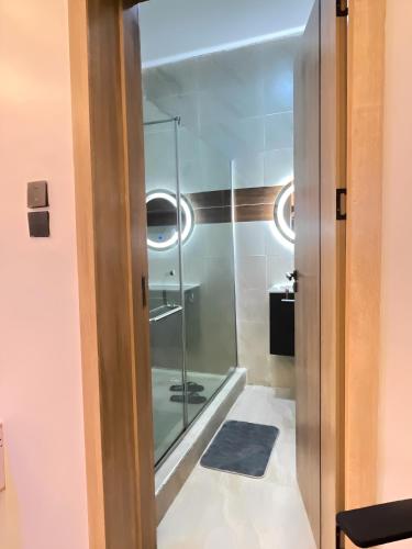 eine Glastür zu einem Badezimmer mit Dusche in der Unterkunft 2-Bedroom Apartment with Pool, Gym, Snooker & Table Tennis in Lekki Ajah in Lekki