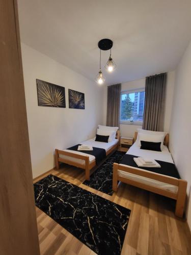 a room with two beds and a window at KRUNA Apartment in Cazin