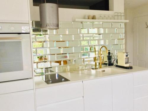 a kitchen with white cabinets and a sink at Apartment Kleines Loft by Interhome in Gais
