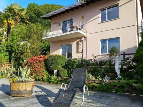 a pair of chairs in front of a house at Apartment Casa Barbara by Interhome in Piazzogna