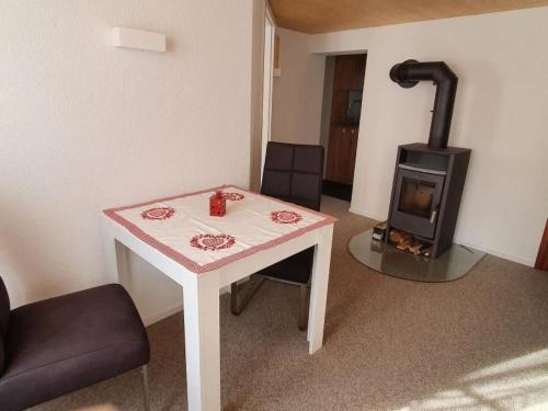 a room with a table and a wood stove at Apartment GLORIOS by Interhome in Heiden
