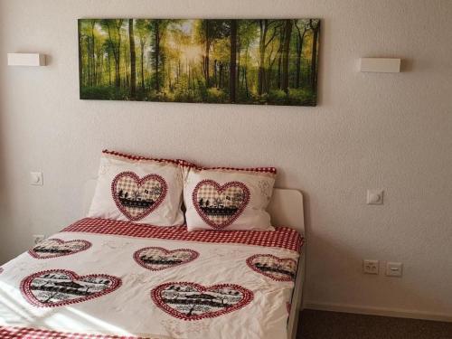 a bedroom with a bed with hearts pillows on it at Apartment GLORIOS by Interhome in Heiden