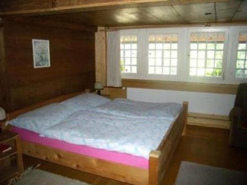 a bedroom with a bed in a room with windows at Apartment Farbhaus Bleiche by Interhome in Rohrbach