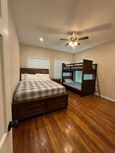 a bedroom with two bunk beds and a ceiling fan at River Side Private Retreat in Seguin