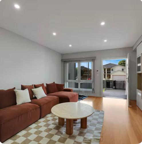 a living room with a couch and a table at Lovely Duplex in Cabramatta West 4 bedrooms in Cabramatta Station