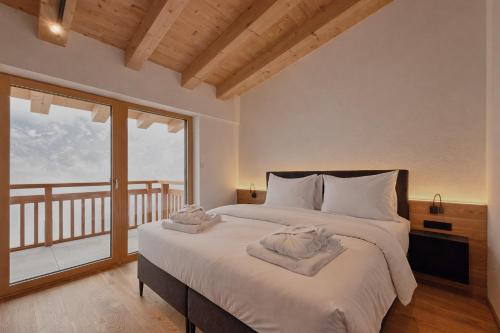 Ένα ή περισσότερα κρεβάτια σε δωμάτιο στο SKYLINE Chalet - AlpenLuxus Collection