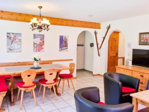 a dining room with a table and chairs at Apartment Curtins16 by Interhome in Pontresina