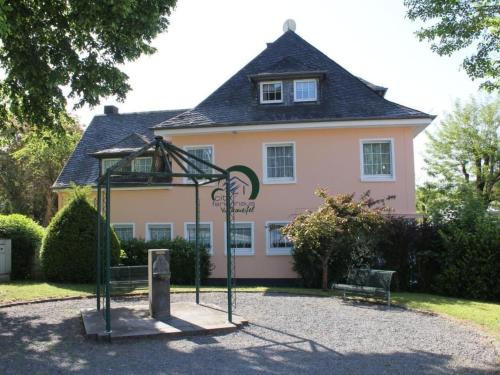 a playground in front of a house with a building at Apartment Vulkaneifel by Interhome in Daun