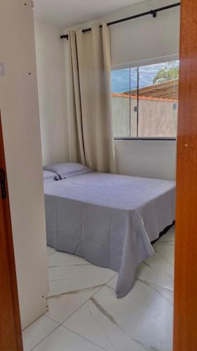 En eller flere senge i et værelse på Casa completa com churrasqueira em Imbituba