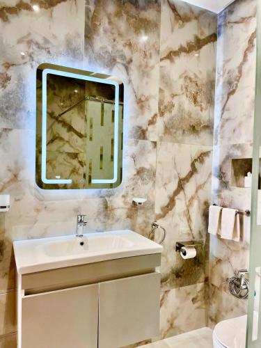 a bathroom with a sink and a mirror at Villa Hasard Marrakech in Had Abdallah Rhiat