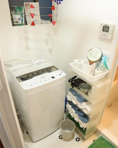 a washer and dryer in a room with a shelf at Japanese Cozy House Near Nagoya Station in Nagoya