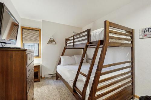 a bedroom with two bunk beds and a dresser at Wapiti Townhouse 3 in Fraser
