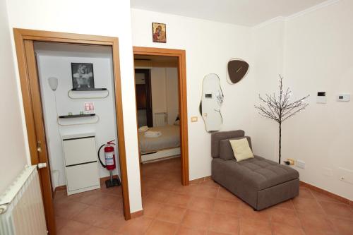 a living room with a couch and a chair at Scavi & Sogni Romani in Ostia Antica
