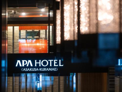a close up of a hotel sign in a window at APA Hotel Asakusa Kuramae in Tokyo