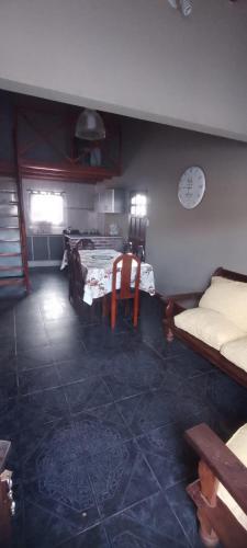 a living room with a couch and a table at Casa con parque para 5 personas in Miramar