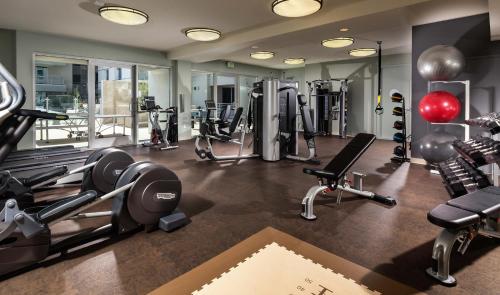a gym with several treadmills and exercise machines at DTLA prime one bedroom steps away from Crypto in Los Angeles