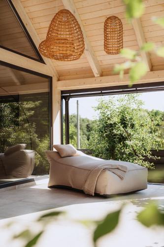 a bedroom with a bed in a room with windows at Villa Lis in Ivano-Frankivsk