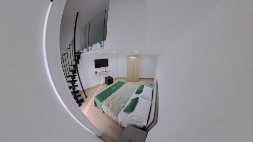 a room with a bed and a spiral staircase at Luxury Home Airport in Naples