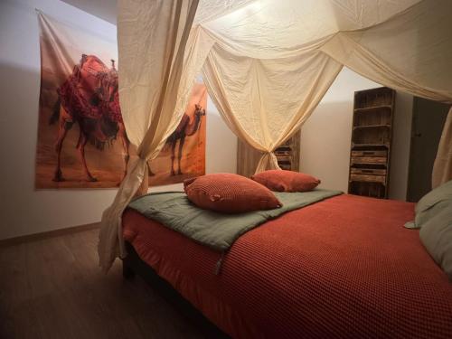 a bedroom with a bed with two pillows on it at Maison Nomade in Feignies