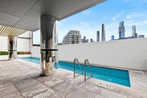 a swimming pool on top of a building at Evermore Apartments in Melbourne